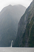 Heavy rain creating waterfalls in Milford Sound, Fjordland National Park on the South Island in New Zealand.