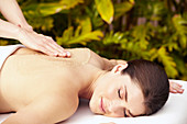 Caucasian woman getting massage with body scrub