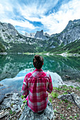 View over the small Gosau lake to the Dachstein and Dachstein glacier with woman in the foreground.
