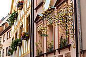 Colorful house facades with golden decorations in Weißgerbergasse, Nuremberg city center, Franconia, Bavaria, Germany