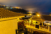 View over villas, landscape and sea at San Marcos, near Icod de los Vinos at night, northwest of Tenerife, Spain