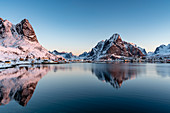 Reine fjord at dawn, with Navaren and Olstinden peaks in winter. Reine, Nordland county, Northern Norway, Norway.