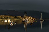 Scotland, Highland, Ross and Cromarty, Ullapool, evening light and stormy sky in front of the harbor