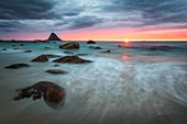 ROCKS AND WHITE SAND ON THE BEACH OF THE VILLAGE OF BLEIK AT SUNSET, ANDOYA, NORWAY