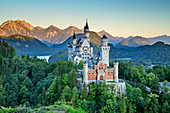 Neuschwanstein Castle in front of Tannheimer Mountains in the dawn, Neuschwanstein, Ammer Mountains, Ammergau Alps, Swabia, Bavaria, Germany