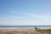 Man in beach chair overlooking Stearns Wharf in Santa Barbara, California, USA: