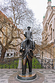The Franz Kafka Monument is located in the area where the Dušní Street and the Vězeňská Street connect, between the Spanish Synagogue and the church of St. Spirit. It is a symbolic place because the Kafka family lived at Dušní Street No. 27. The statue is within the spiritual zone of three Churches – Jewish, Catholic and Protestant. Franz Kafka practically lived his entire short life in this sad (in those days) yet romantic part of the old Prague. The monument was inspired by an important short story written by Kafka called "Popis Jednoho Zápasu" (Description of a Match). The "split" design of