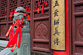 Red prayer ribbons in the courtyard of the Jade Buddha Temple, a Buddhist temple in Shanghai, China.