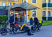 Couple with packed bicycles and dog on a long bike tour, Passau, Bavaria
