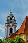Blue church tower and colorful house in Dürnstein an der Donau, Wachau, Austria