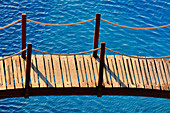 A small wooden bridge leads over a swimming pool, Castellon de la Plana, Spain