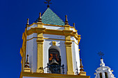 Yellow and white church tower against an azure blue sky, Ronda, Andalusia, Spain