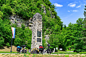 Packed travel bicycles with dog trailers on the roadside in front of a monument, near Klanjec, Croatia