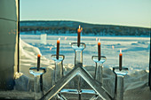 A window with candles in an ice candle holder at the ICEHOTEL 365 which was launched in 2016 and is a permanent structure offering year round the stay in the Icehotel in Jukkasjarvi near Kiruna in Swedish Lapland; northern Sweden.