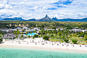 Resort on Flic en Flac beach with Piton de la Petite Riviere Noire mountain in background, aerial view, Black River, Mauritius