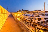 France, Alpes-Maritimes, Antibes, the ramparts of the port Vauban in the quay Henri Rambaud with in background the saracen towers of the castle Grimaldi of the old town