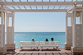 France, Alpes Maritimes, Nice, the Baie des Anges, womans sitting on a bench of the Promenade des Anglais