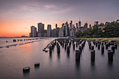 View across the water of New York City,Manhattan island,at dawn,flat calm water.