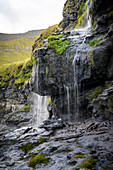 View of a small waterfall in Mikladalur, Kalsoy, Faroe Islands, Denmark.