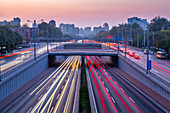 Traffic trail lights on major road near Beijing Zoo at dusk, Beijing, People's Republic of China, Asia