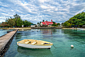 Boat moored in the sea surrounding the Notre Dame Auxiliatrice Church, Cap Malheureux, Mauritius, Indian Ocean, Africa