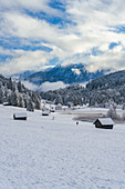 Blick über den gefrorenen Geroldsee auf schneebedeckte Landschaft, Krün, Bayern, Deutschland.