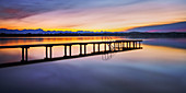 Jetty on Lake Starnberg at sunset with a view of the mountains, St. Heinrich, Bavaria, Germany
