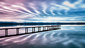 Jetty on Lake Starnberg at sunset with a view of the mountains, St. Heinrich, Bavaria, Germany