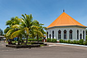 Coconut palms and Catholic Church Église de Saint Michel in Papetoai, Moorea, Windward Islands, French Polynesia, South Pacific