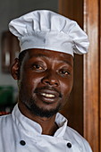 Friendly cook in the kitchen of the restaurant of the Rushel Lodge on the banks of Lake Kivu, Kinunu, Western Province, Rwanda, Africa
