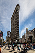 People gather at the Flatiron Building to drink coffee and take in the sun, Manhattan, New York, United States of America, North America