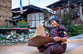 Traditional rice sifting at Tshangkha Village, near Trongsa, Bhutan, Asia