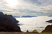 Man and tent above the clouds, Trentino-Alto Adige, South Tyrol in Bolzano district, Alta Pusteria, Hochpustertal,Sexten Dolomites, Italy
