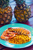 Colourful plate with lobster tail and shrimps in an outdoor restaurant on Cayo Blanco, Cuba