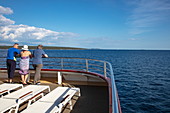Three people on the railing of the cruise ship in the Adriatic Sea, near Kampor, Primorje-Gorski Kotar, Croatia, Europe