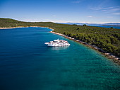 Aerial view of cruise ship in pristine bay at a swim stop for passengers, Šolta, Split-Dalmatia, Croatia, Europe