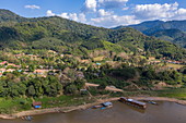 Aerial view of river cruise ship Mekong Sun moored along the sandy bank of the Mekong River, Pak Tha District, Bokeo Province, Laos, Asia