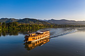 Aerial view of river cruise ship Mekong Sun on river Mekong with mountains behind, Chomphet District, Luang Prabang Province, Laos, Asia