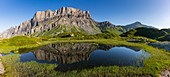 France, Haute-Savoie, Passy, Plaine Joux, reflection of the Rochers des Fiz in Lake Pormenaz (1970m)