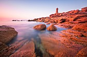 France, Cotes d'Armor, Pink Granite Coast, Perros-Guirec, on the Customs footpath or GR 34 hiking trail, Ploumanac'h or Mean Ruz lighthouse at sunset