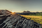 broken hut at sunrise on the Seiser Alm in South Tyrol, Italy, Europe;