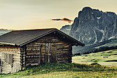 Hut at sunrise on the Seiser Alm in South Tyrol, Italy, Europe;