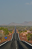 The highway runs lonely in the heat through the outback, Kununurra, Western Australia, Australia