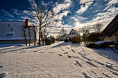 Snow-covered country houses. Dorum, Lower Saxony, Germany