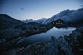 Illuminated mountain hut in the Swiss mountains, Switzerland, mountain range, mountain hut,
