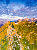 Clouds at dawn over the majestic peaks of Santis and Saxer Lucke, aerial view, Appenzell Canton, Alpstein Range, Switzerland, Europe