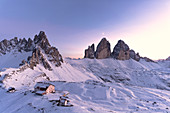Sonnenuntergang über Monte Paterno, Tre Cime di Lavaredo und Locatelli Hütte mit Schnee bedeckt, Sesto Dolomiten, Südtirol, Italien, Europa