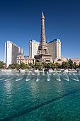View across lake to replica Eiffel Tower at the Paris Hotel and Casino, Bellagio fountains in foreground, Las Vegas, Nevada, United States of America, North America