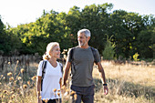Smiling mature couple hiking in forest