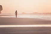 Woman walks on the beach in sunset, Portugal, beach, vacation